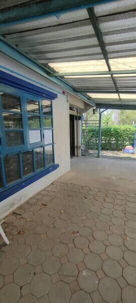 Covered outdoor patio with blue-framed windows