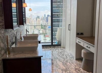 modern bathroom with dual sinks and city view