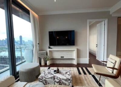 Modern living room with city view, TV, and comfortable seating