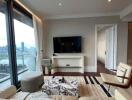 Modern living room with city view, TV, and comfortable seating