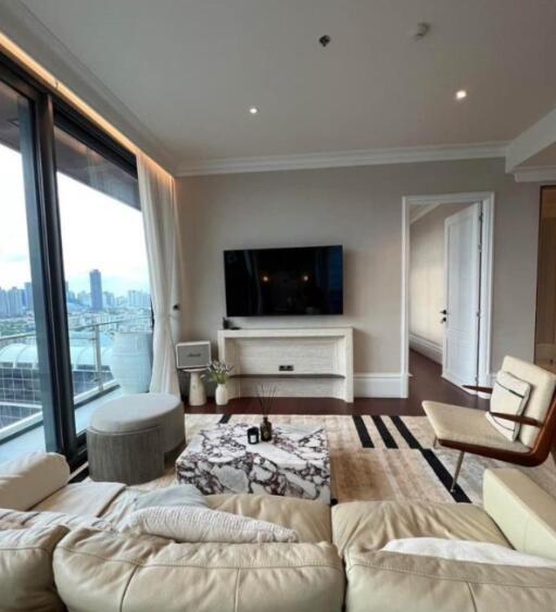 Modern living room with city view, TV, and comfortable seating