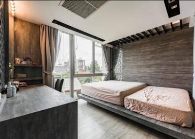 Modern bedroom with double bed, large windows, and workspace