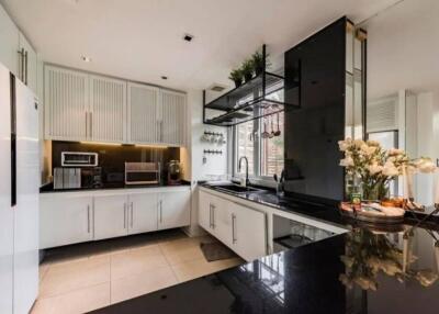 Modern kitchen with black countertops and built-in appliances