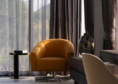 Modern living room with yellow armchair and floor-to-ceiling windows