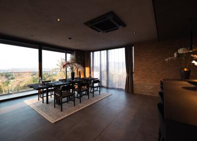 Modern dining area with large windows and elegant decor