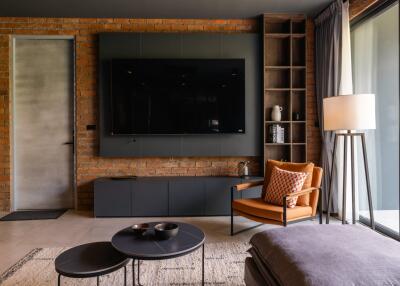 modern living room with brick wall and large TV