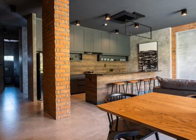 Modern kitchen and dining area with exposed brick and sleek design