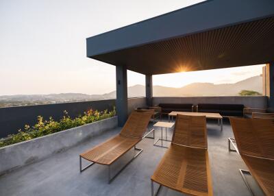 Modern rooftop terrace with lounge chairs and scenic view