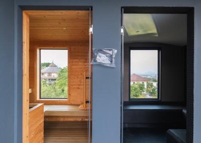 A modern bathroom with two separate areas, one with wooden finishes and another in a dark color scheme.