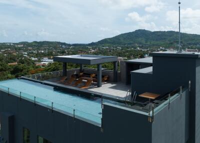 Modern rooftop terrace with pool and lounging area