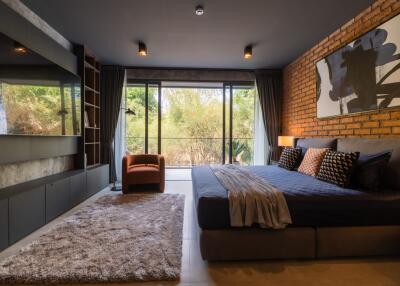 Spacious modern bedroom with large windows and a comfortable bed