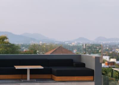 Rooftop lounge area with pool and scenic view