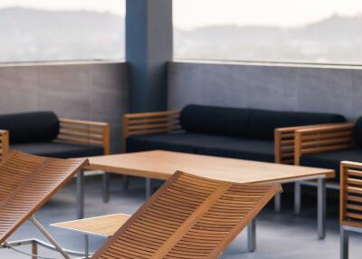 Modern rooftop patio with lounge seating and mountain view