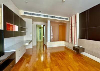 Spacious living room with wooden flooring and modern built-in shelving