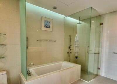 Modern bathroom with bathtub and glass-enclosed shower