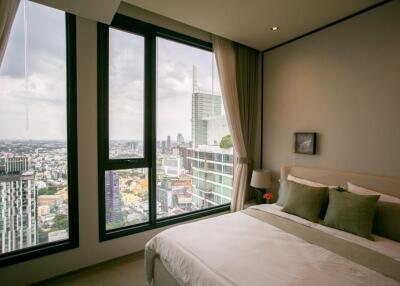 Bedroom with city view windows