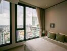 Bedroom with city view windows