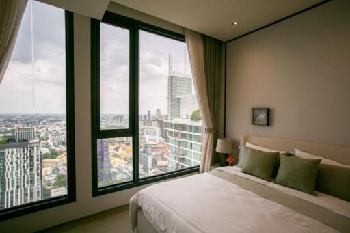 Bedroom with city view windows