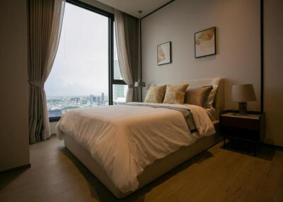 Spacious bedroom with a large window and stylish décor