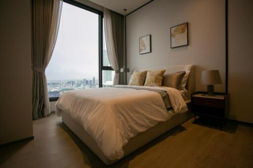 Spacious bedroom with a large window and stylish décor