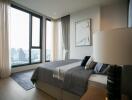 Modern bedroom with large windows and city view