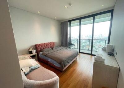 Bedroom with a bed, couch, large windows and city view