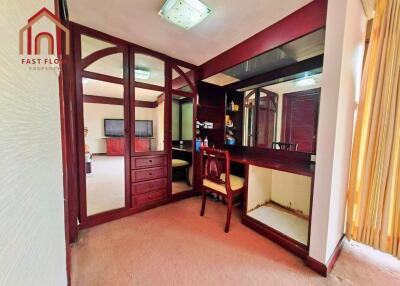 Bedroom with mirrored closet and dressing area