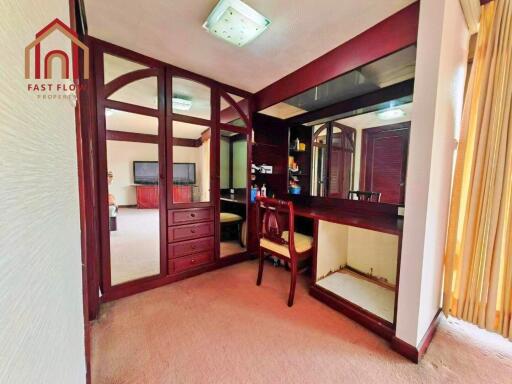 Bedroom with mirrored closet and dressing area