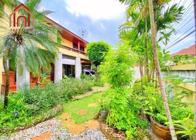 Exterior view of a two-story house with garden