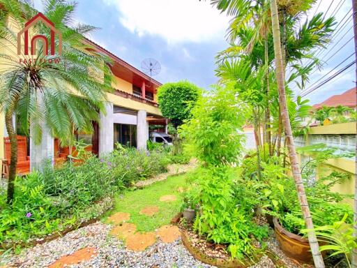 Exterior view of a two-story house with garden