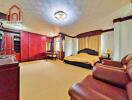 Spacious master bedroom with red cabinetry and comfortable seating