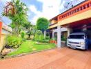 Front yard with driveway and car