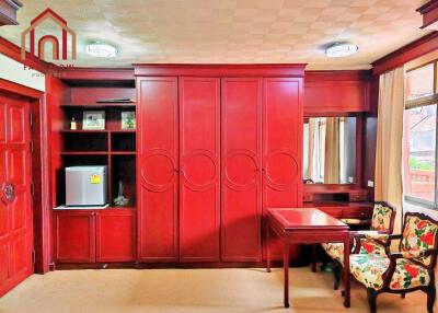 Bedroom with built-in wooden wardrobe and furniture