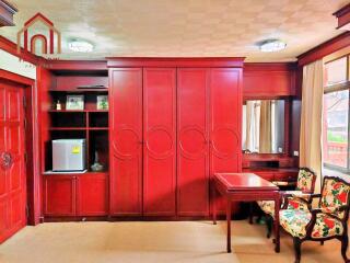 Bedroom with built-in wooden wardrobe and furniture