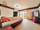 Spacious bedroom with a large bed, balcony access, and ample natural light