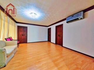 Spacious living room with wooden flooring and modern furnishings