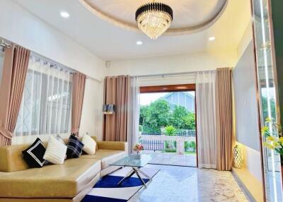 Modern living room with chandelier and large windows