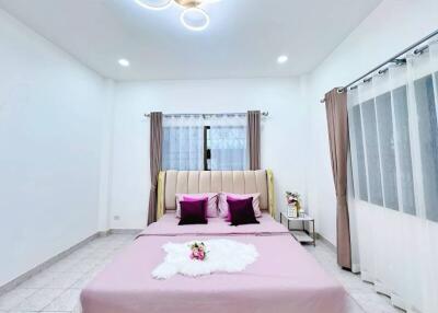 Modern and spacious bedroom with contemporary light fixture