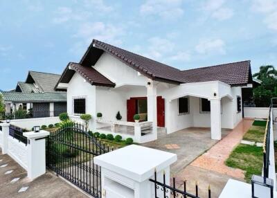 Exterior view of a modern house with a front yard and a driveway