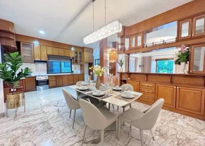 Spacious kitchen and dining area with modern appliances and elegant decor