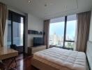 Modern bedroom with a large bed and city view