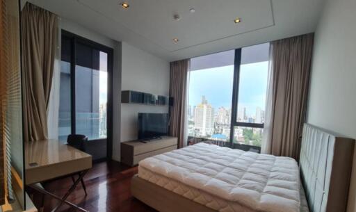 Modern bedroom with a large bed and city view