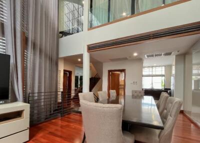 Modern dining room with high ceiling and large windows