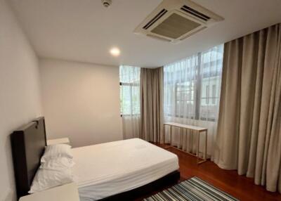 Modern bedroom with large windows and natural light