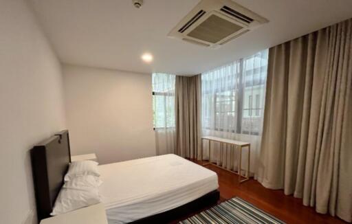 Modern bedroom with large windows and natural light