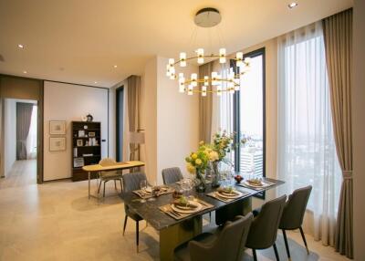 Modern dining room with a stylish chandelier and city view