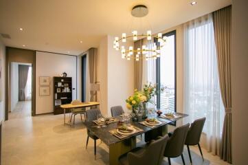 Modern dining room with a stylish chandelier and city view