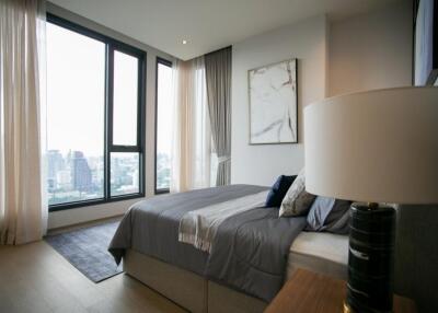 Modern bedroom with large windows and city view