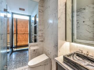 Modern bathroom with marble walls and stylish fixtures