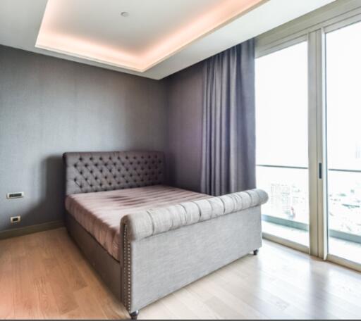 Modern bedroom with floor-to-ceiling window and balcony access